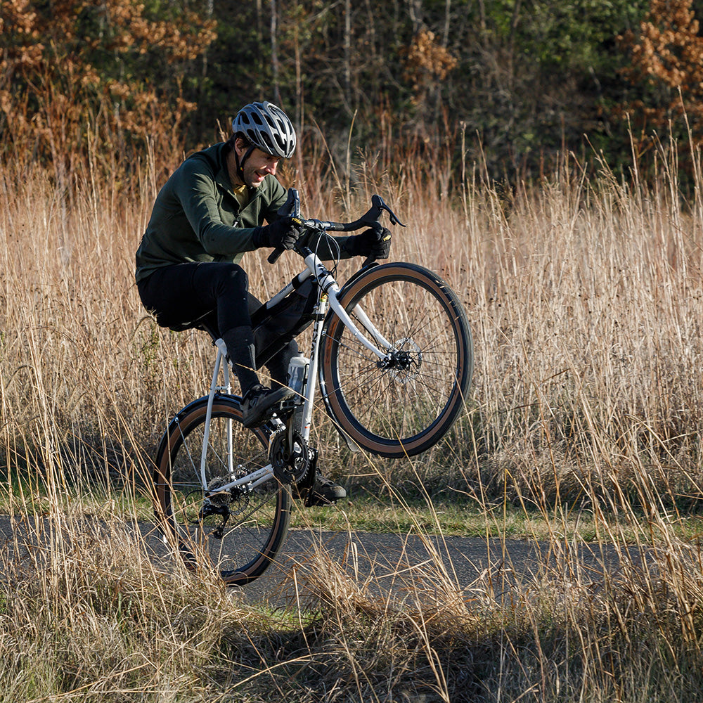 Cyclist riding wheelie on drop bar Surly Midnight Special