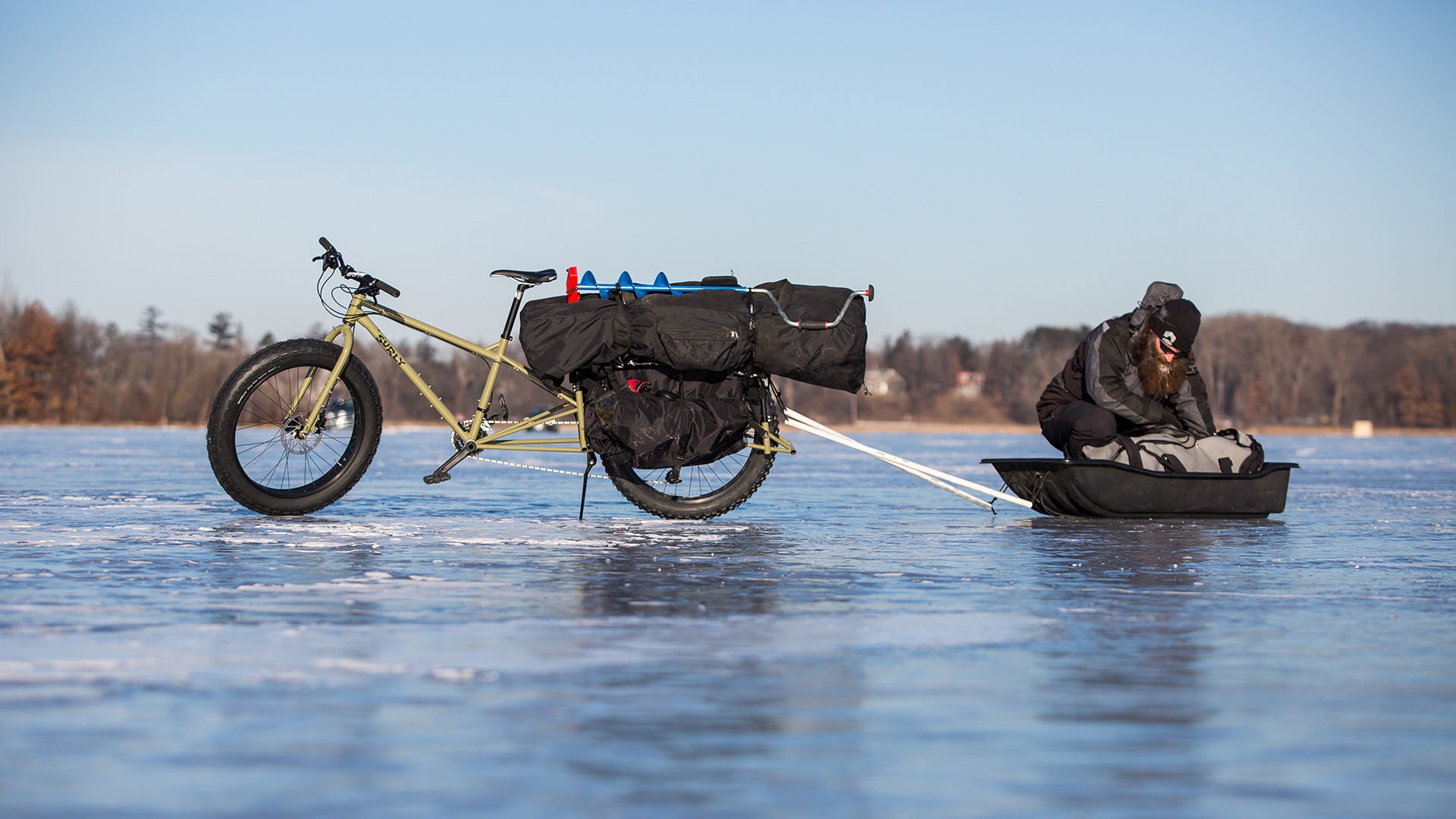 Hauling ice fishing gear and sled on frozen lake