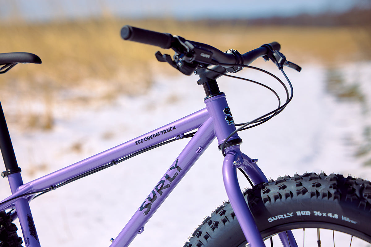 Surly Ice Cream Truck purple color focus on front end of bike outside on snow