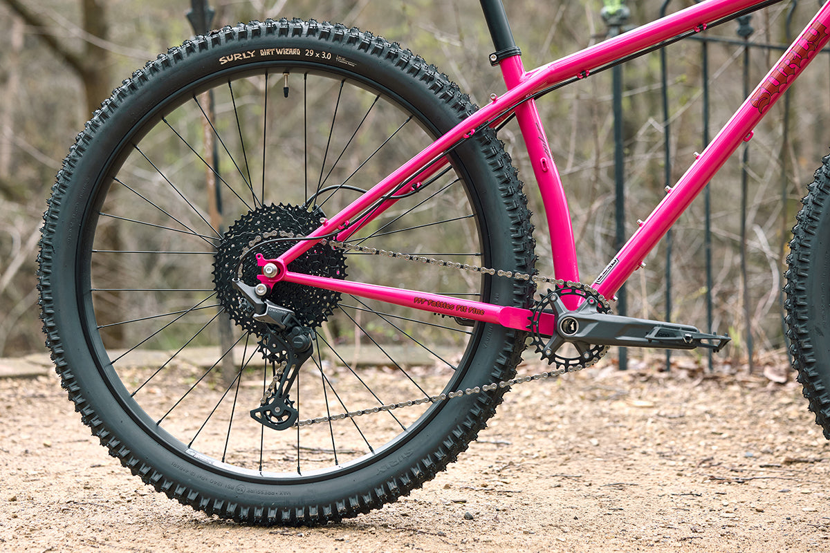 Surly Krampus Bike Prickly Pear color rear wheel, crank, and seat tube are focus outside