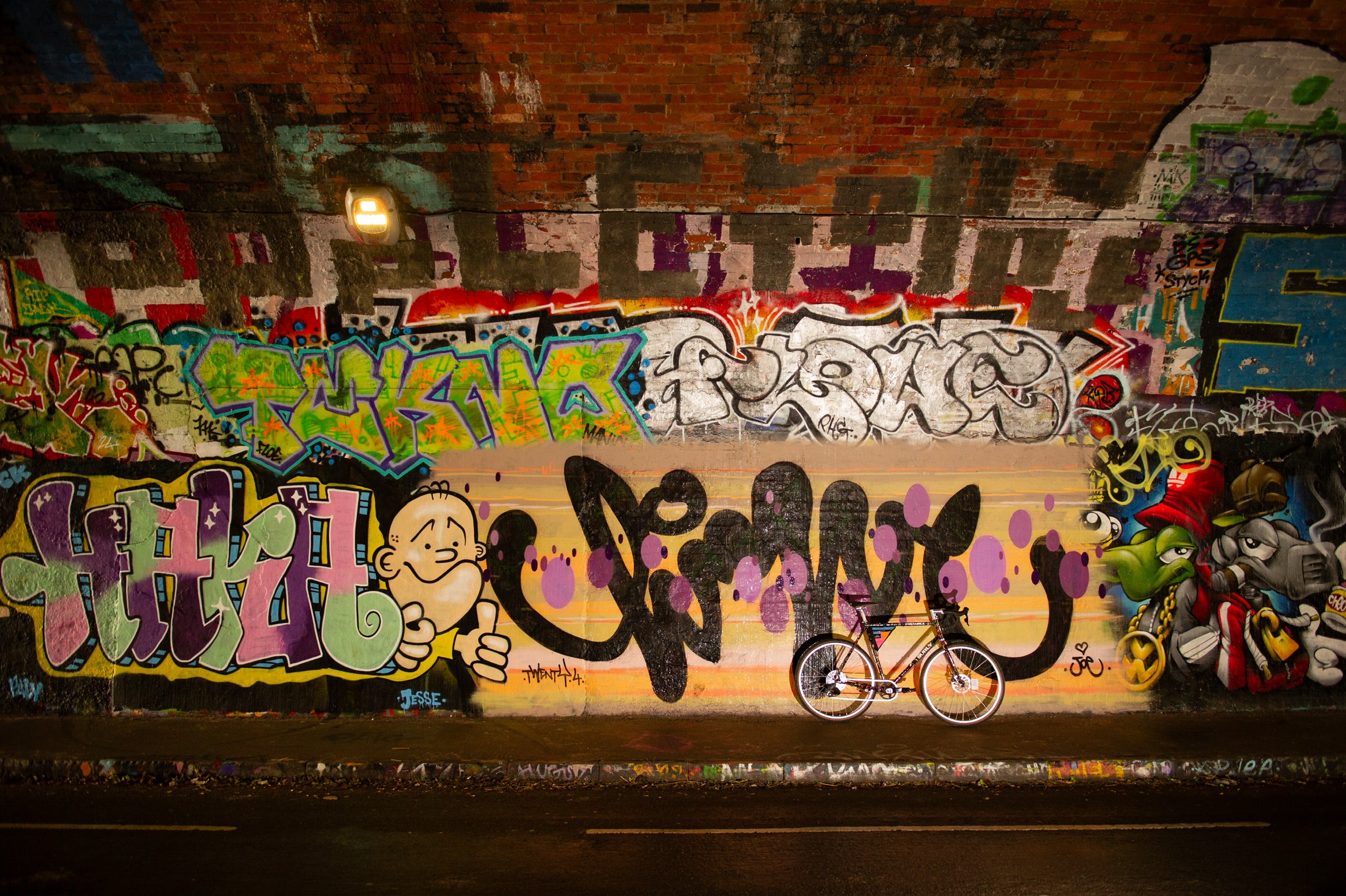 Inside tunnel custom Surly Preamble leaning against wall showing graffiti