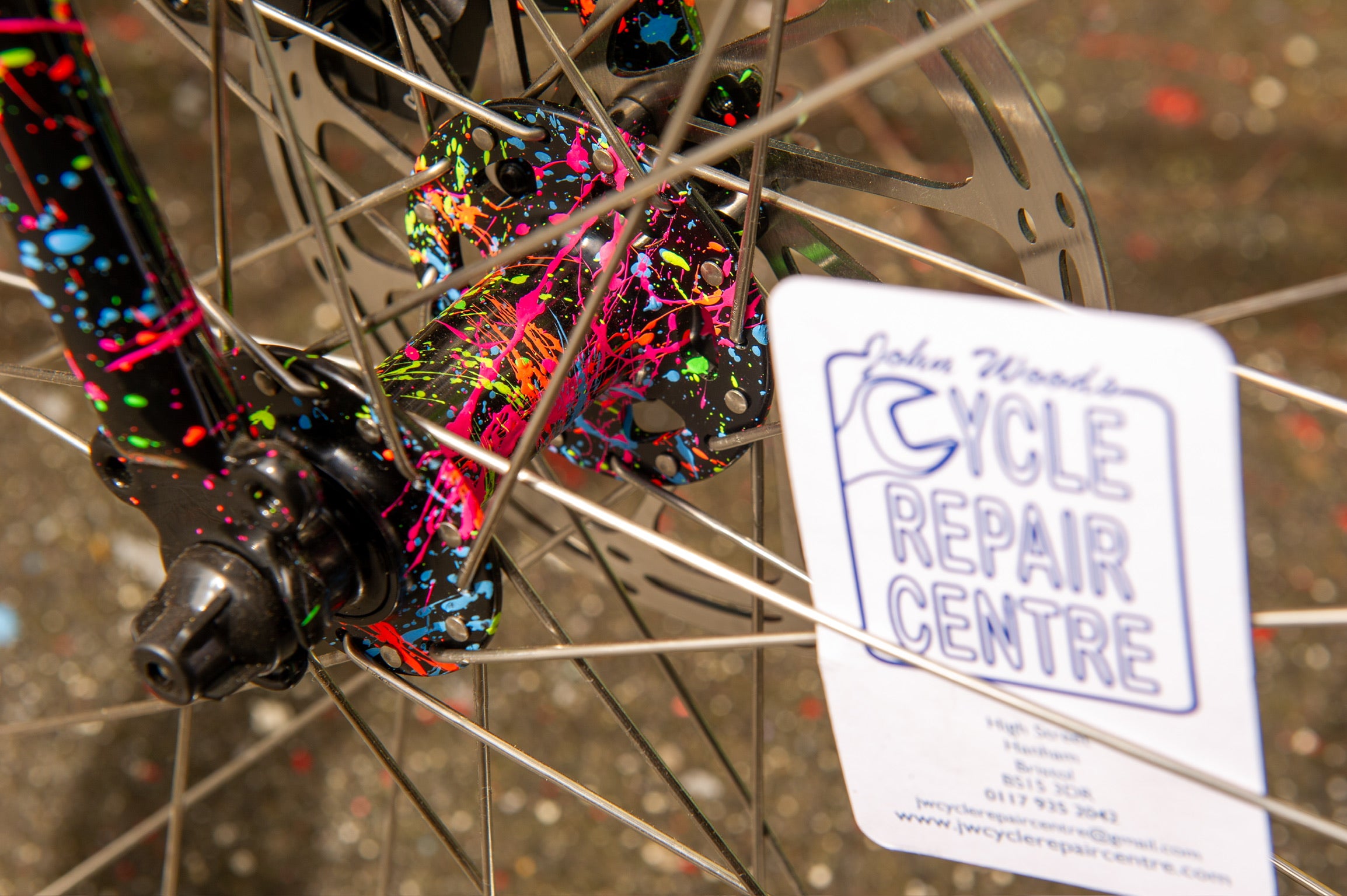 Close-up of custom splatter paint on fork and front hub of Surly Preamble bike