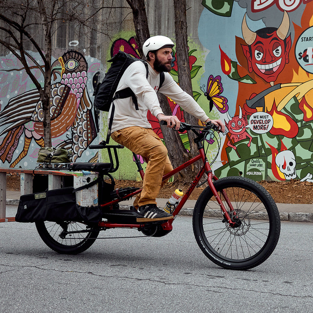 Person riding fully loaded Surly Big Easy cargo Ebike