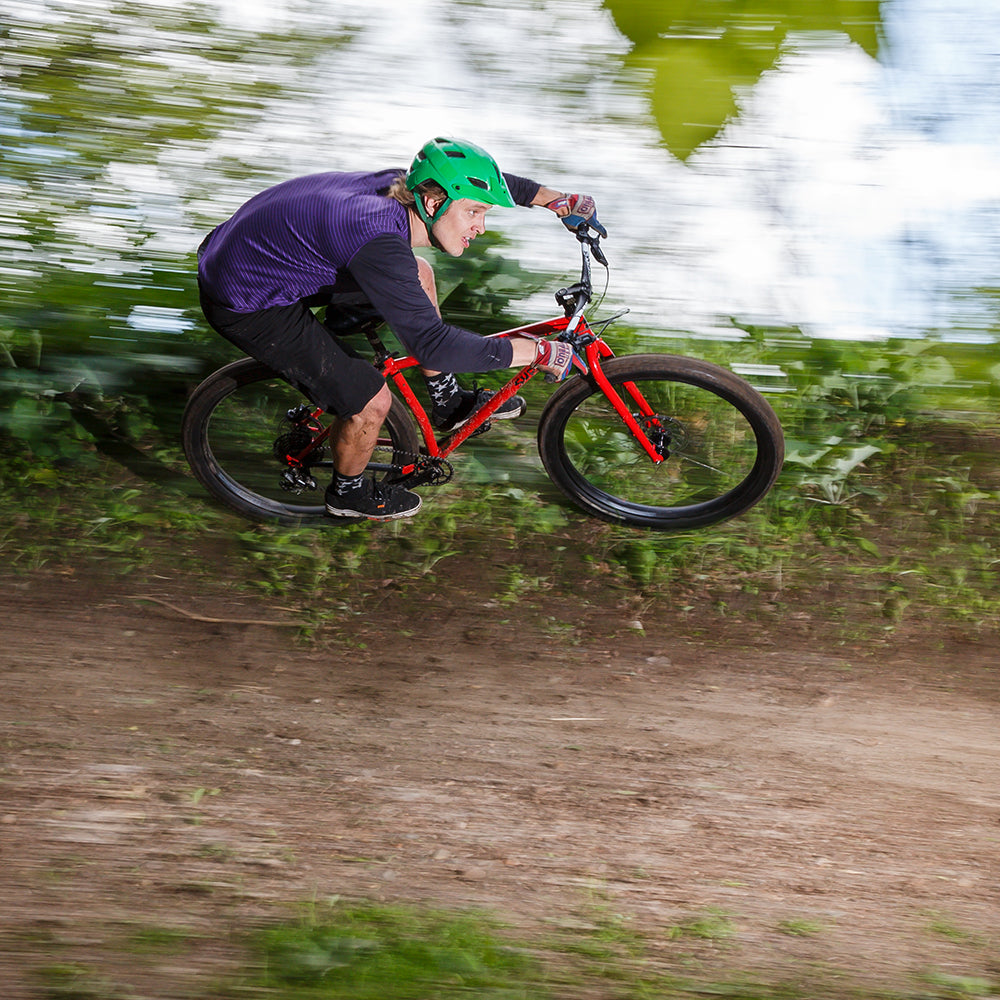 Person riding Surly Krampus on berm at speed