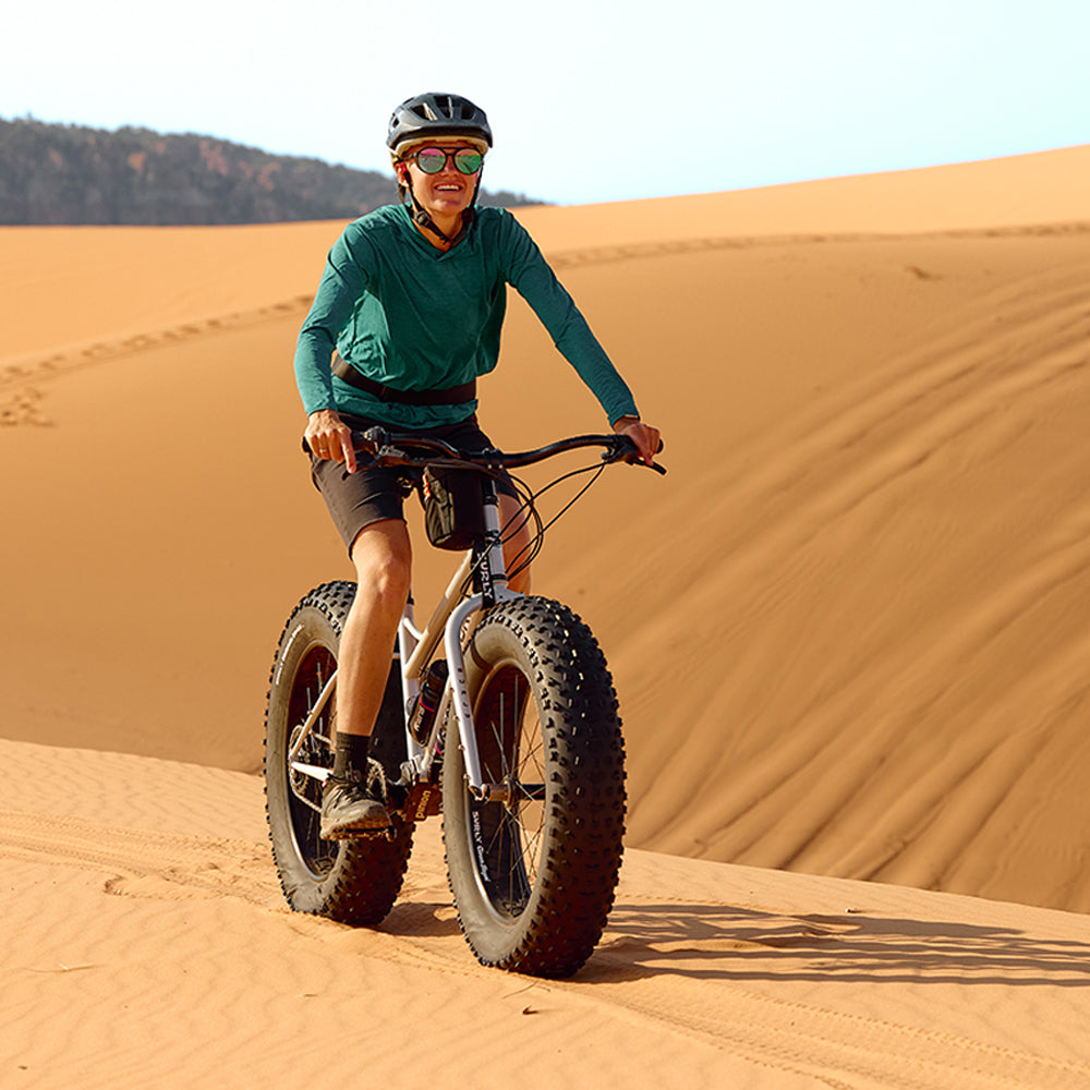 Person riding Surly Moonlander on sand dunes