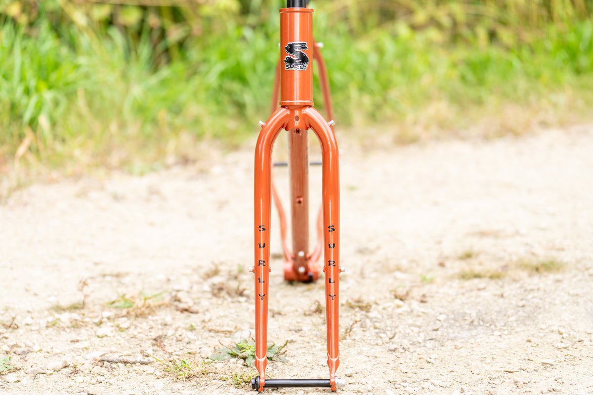 Surly Straggler Frameset in Shaggy Carpet orange color straight on view on gravel road