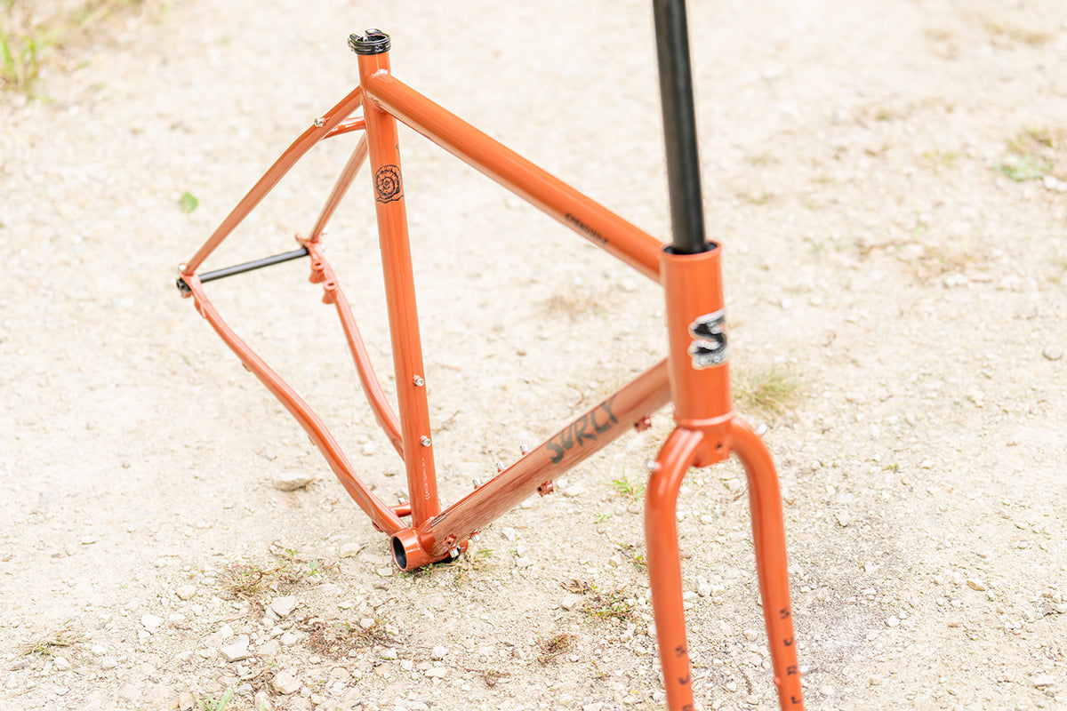 Surly Straggler Frameset in Shaggy Carpet orange color top down view of frame outside on gravel road