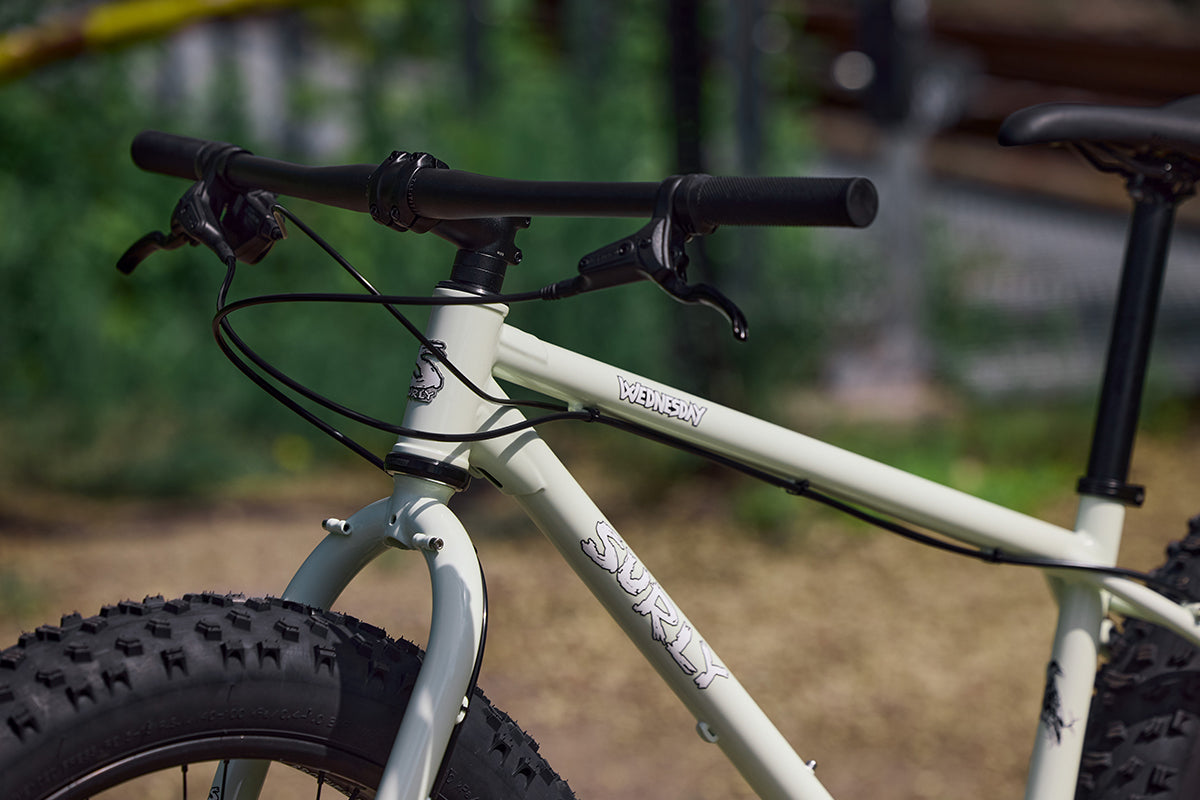 Close-up of a Surly Wednesday bike with blurred outdoor background