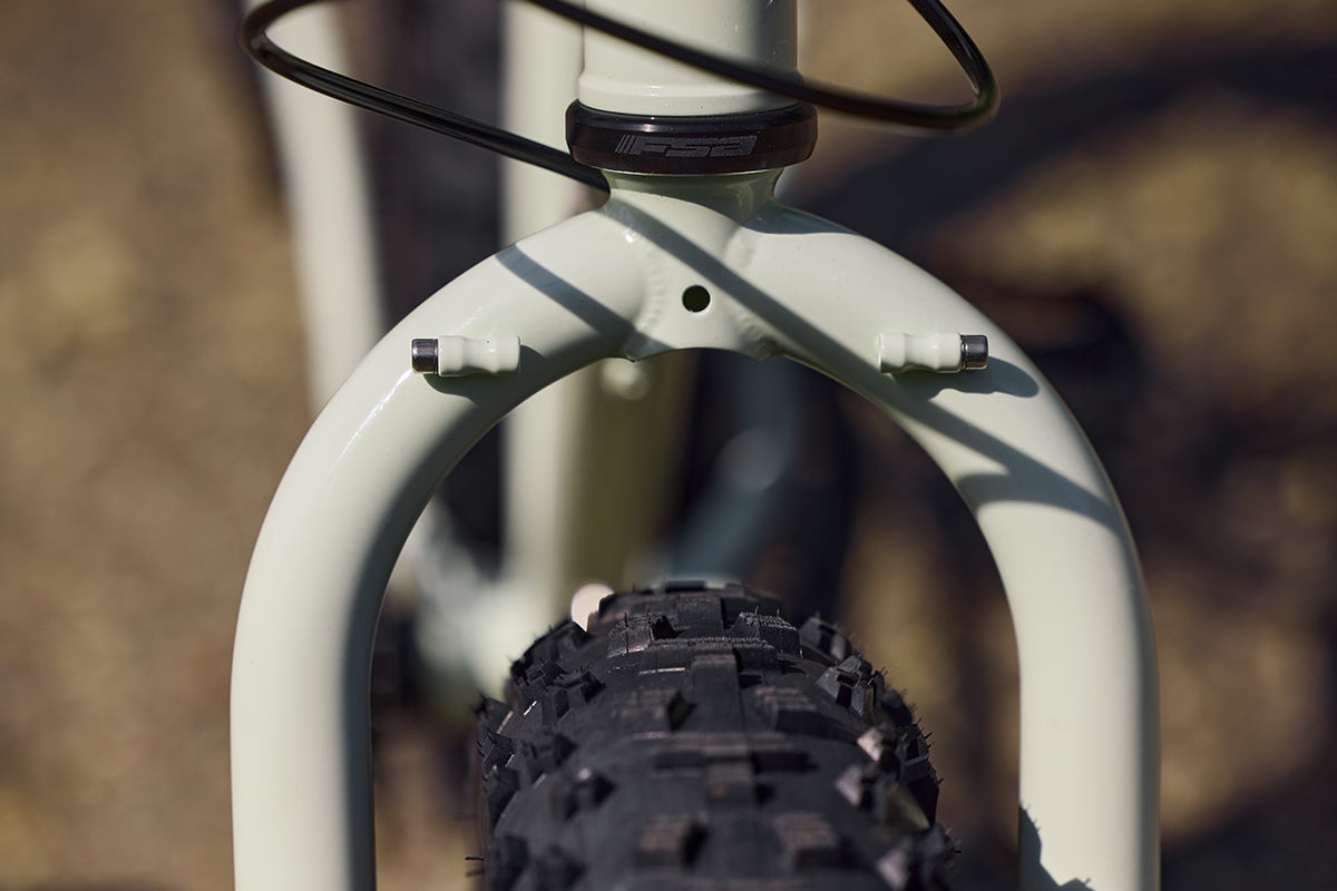 Close-up of a bicycle fork with a blurred background